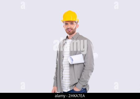Construction Worker Holding House Plan in Hands. Architect Holding Blueprints. Yellow Hard Helmet. Worker Stock Photo