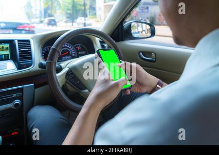 Driving car and using phone. Distracted driver texting with mobile cellphone. Irresponsible man checking message with smartphone in traffic. Auto acci Stock Photo
