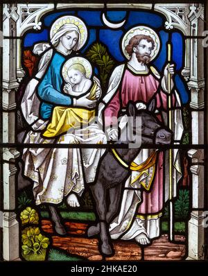 Stained glass window Pakenham church, Suffolk, England, UK c 1887 looks Heaton, Butler and Baynes detail Flight into Egypt Stock Photo