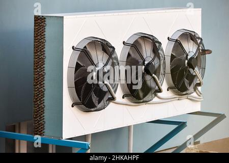 Air condition machine on commercial warehouse building wall side view. Condition and cooling system HVAC. Industrial air conditioner units of Stock Photo