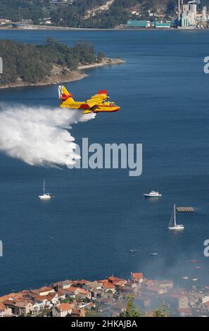 plane drops water on a forest fire Stock Photo - Alamy