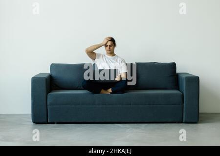 Upset desperate man having problems with wasting money, overspending,, scam and digital fraud. Stock Photo