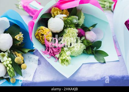 Flower composition with white and pink roses and other flowers. Bridal bouquet with creamy roses and peonies. Farewell Bell. day of knowledge. beginning of the school year. Stock Photo