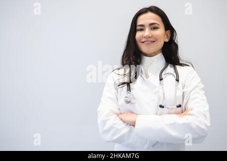 Portrait of a happy female doctor with arms crossed Stock Photo