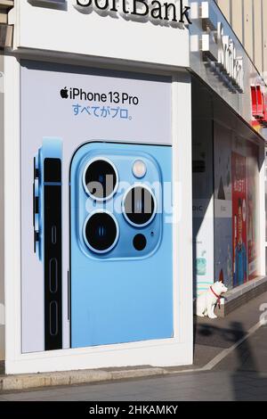TOKYO, JAPAN - February 3, 2022: Poster advertising the iPhone 13 pro on a Softbank mobile store in Tokyo's Roppongi area. Stock Photo