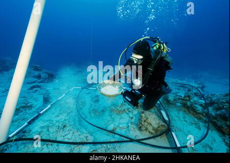 Underwater archaeologists digging BC 2nd century shipwreck in Bozburun Marmaris Turkey.