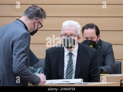 Stuttgart, Germany. 03rd Feb, 2022. Winfried Kretschmann (r, Bündnis 90/Die Grünen), Minister President of Baden-Württemberg speaks with Andreas Schwarz, parliamentary group leader of Bündnis 90/Die Grünen in the state parliament of Baden-Württemberg, before the start of a plenary debate. Credit: Bernd Weißbrod/dpa/Alamy Live News Stock Photo