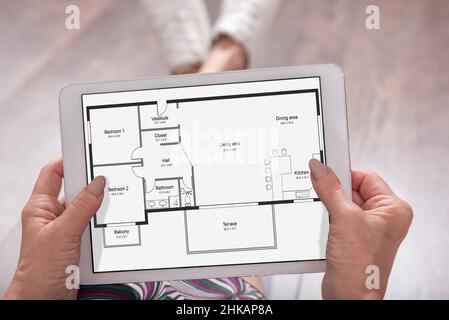 Apartment plan concept shown on a tablet held by a woman Stock Photo