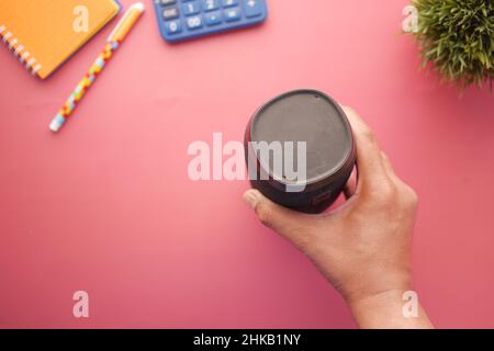 man's hand using smart speaker on table  Stock Photo