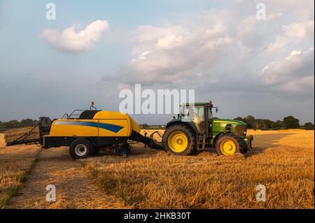 Process of hay making during harvesting Stock Photo - Alamy