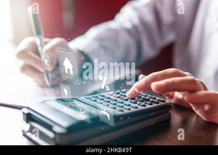 Woman writing and using a calculator,  businesswoman or student. Working from home concept, virtual screen, icons, copy space Stock Photo