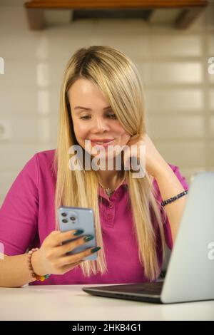 Happy violence survivor woman communicating online with modern mobile phone. Domestic abuse victim person with face scar and prosthetic eye using new Stock Photo