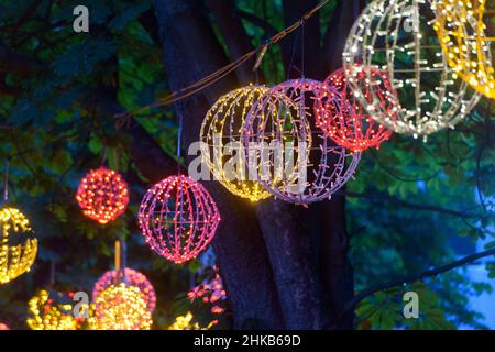 light garlands in the form of a ball hung on a tree Stock Photo
