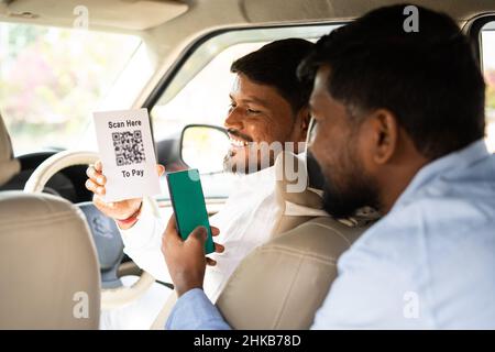 tsunamien Vær forsigtig F.Kr. Foucs on cab driver passanger paying to taxi driver by scanning bar code  after ride - conept of online secure payment, banking technology and Stock  Photo - Alamy