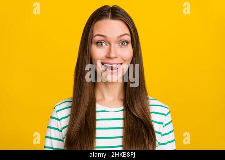 Photo of pretty childish lady dressed striped shirt smiling stick out isolated yellow color background Stock Photo