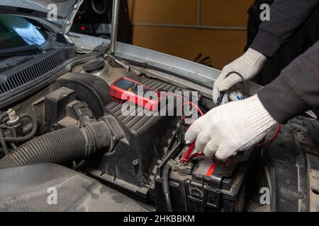Auto Mechanic Check Car Battery Voltage By Voltmeter Multimeter Stock Photo  - Download Image Now - iStock