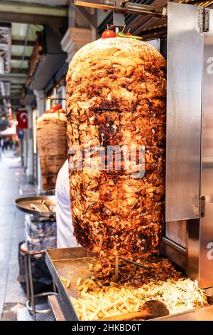 Grilled chicken meat on a vertical rotisserie used in traditional turkish street food Doner Kebab (Shawarma or Gyros in other cultures) in Istanbul, T Stock Photo