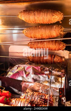 Rolls of Kokorech (Kokorec) roasting on wood fire in Istanbul, Turkey, a traditional turkish street food made of lamb or goat intestines Stock Photo