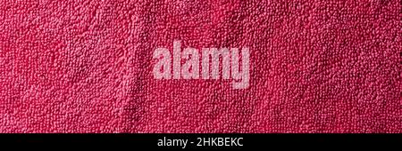 a fuchsia purple terrycloth fabric to be used as a background, in a panoramic format to use as web banner or header Stock Photo