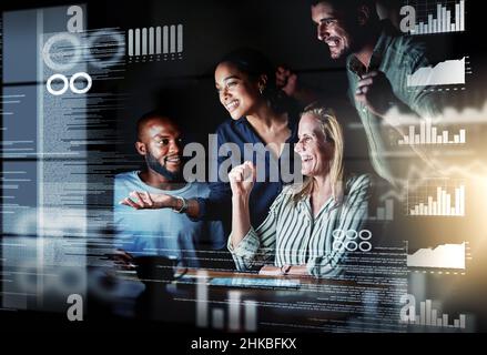 We totally cracked it. Shot of a group of programmers working together on a computer code at night. Stock Photo