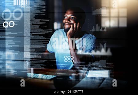 Cyberspace is his favourite place. Shot of a programmer working on a computer code at night. Stock Photo