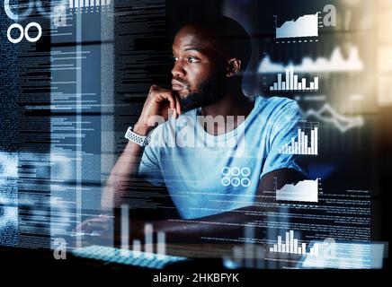 Working in a new dimension. Shot of a programmer working on a computer code at night. Stock Photo