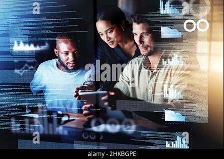 Diving into new networks. Shot of a group of programmers using a digital tablet while working together on a computer code at night. Stock Photo