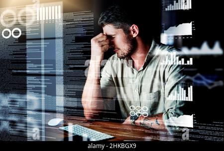 He's just too overwhelmed. Shot of a programmer looking stressed out while working on a computer code at night. Stock Photo