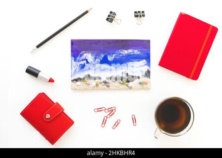 Resin art, red wallet and diary and coffee mug on white background. Flat lay, Top view Stock Photo