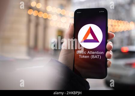 Kharkov, Ukraine - February 2, 2022: Basic Attention Token BAT symbol. Trade with cryptocurrency, digital and virtual money, mobile banking. Hand with Stock Photo