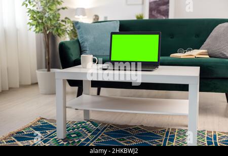 Green screen laptop on table Stock Photo