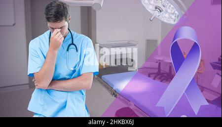 Digital composite image of blue awareness ribbon and caucasian young male doctor with head in hand Stock Photo