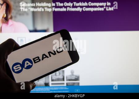 Rheinbach, Germany  2 February 2022,  The brand logo of the Turkish company 'Sabancı Holding' on the display of a smartphone in front of the website Stock Photo