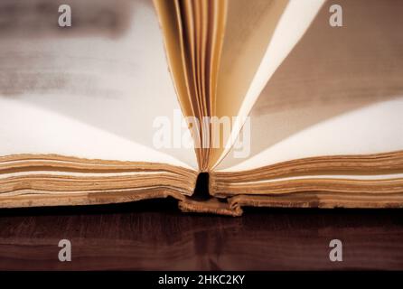 Open book, low angle view, close up. Open book on a table. Vintage books. Stock Photo