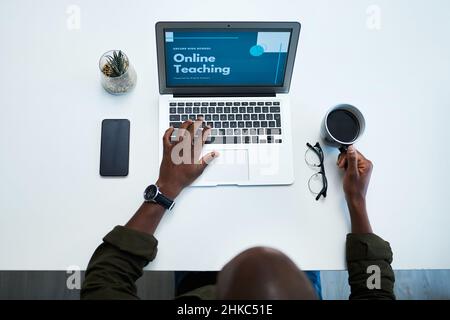 Stay connected, stay qualified. High angle shot of a man using a digital tablet to have an online lesson. Stock Photo