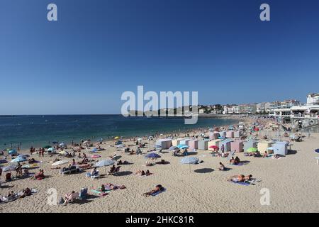 Colourful stripy bathing tents on the Grande Plage beach at St Jean de Luz, Pays Basque, Pyrenees Atlantiques, France Stock Photo