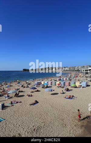 Colourful stripy bathing tents on the Grande Plage beach at St Jean de Luz, Pays Basque, Pyrenees Atlantiques, France Stock Photo