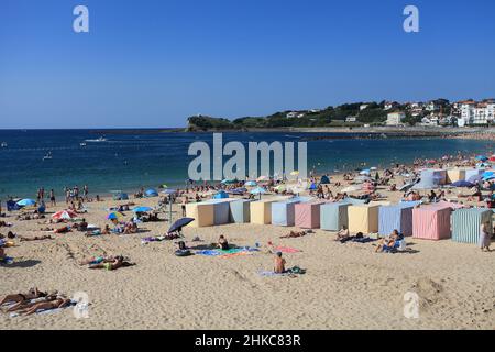 Colourful stripy bathing tents on the Grande Plage beach at St Jean de Luz, Pays Basque, Pyrenees Atlantiques, France Stock Photo