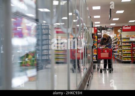 Washington, USA. 12th Jan, 2022. A customer shops at a Target store in New York, the United States, Jan. 12, 2022. TO GO WITH XINHUA HEADLINES Credit: Wang Ying/Xinhua/Alamy Live News Stock Photo