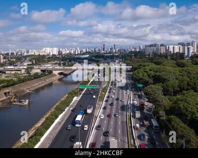Beautiful drone aerial view of Marginal Tiete river avenue, Sao Paulo city skyline on summer sunny day. Cars, trees and buildings. Concept of urban. Stock Photo