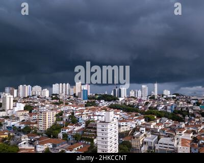 Dramatic drone aerial view of summer rain clouds in Pompeia neighborhood buildings and houses in São Paulo city before storm and flooding street. Stock Photo