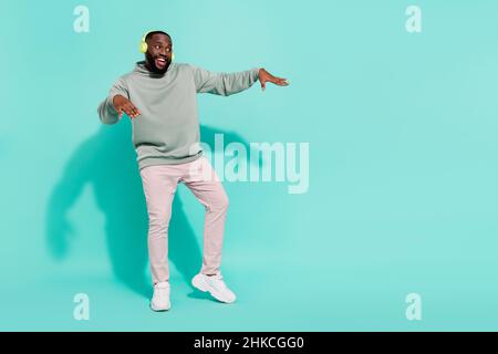 Full length body size view of cheerful attractive guy dancing hip hop moving copy space isolated over shine teal turquoise color background Stock Photo