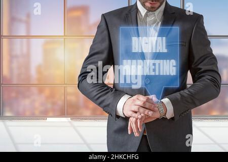 Businessman pressing smartwatch displaying hologram digital marketing Stock Photo