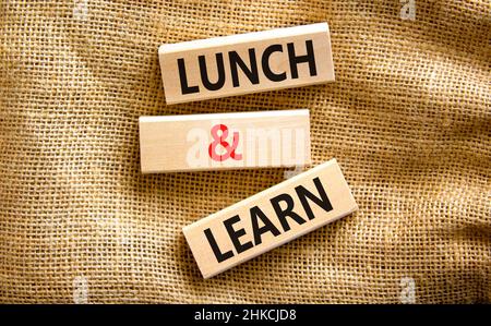 Lunch and learn symbol. Concept words Lunch and learn on wooden blocks. Beautiful canvas table canvas background. Copy space. Business, educational an Stock Photo