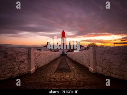 The cobbled pathway to the red and white striped, 23 meter tall,  Souter Lighthouse in Marsden, South Shields as the sun rises Stock Photo