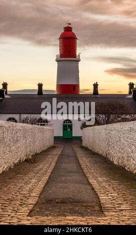 The cobbled pathway to the red and white striped, 23 meter tall,  Souter Lighthouse in Marsden, South Shields as the sun rises Stock Photo