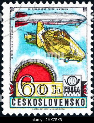 CZECHOSLOVAKIA - CIRCA 1977: a stamp printed in Czechoslovakia shows zeppelin, 1909 and 1928, history of aviation, circa 1977 Stock Photo