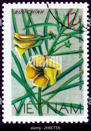 VIETNAM - CIRCA 1977: a stamp printed in Vietnam shows yellow oleander, thevetia peruviana, is a poisonous plant, wildflower, circa 1977 Stock Photo