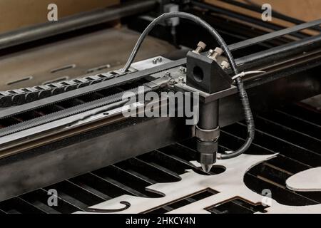 The process of laser cutting on wood on the equipment and tool of the laser machine in the industrial plant. Stock Photo