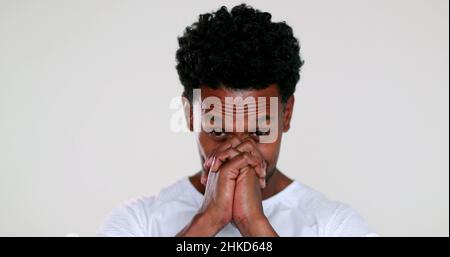 African man feeling hopeful with sign of prayer and faith portrait smiling and charismatic being grateful Stock Photo